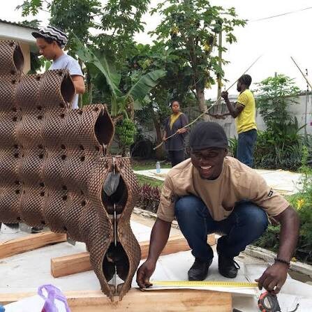 Assembly of coconut-husk panel modules in Ghana