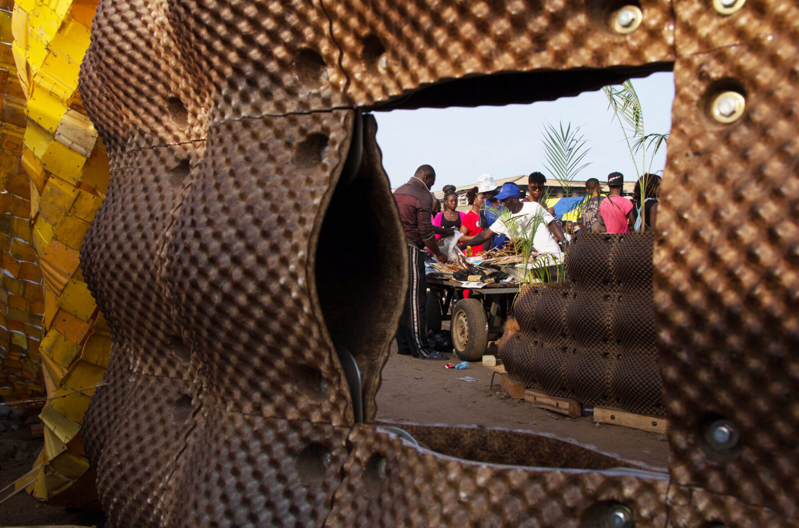 View through modular coconut-husk panels at the CASE Chale Wote Upcycling Pavilion in Ghana